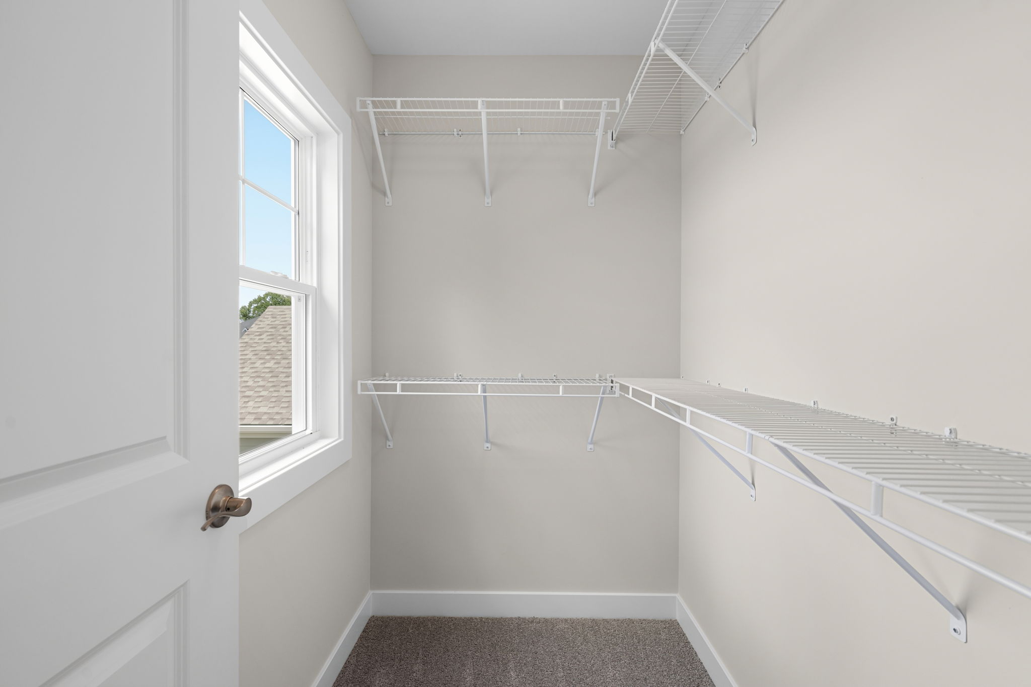 Upstairs bedroom closet with shelving at 9312 Woodgate Circle in Alvaton, KY