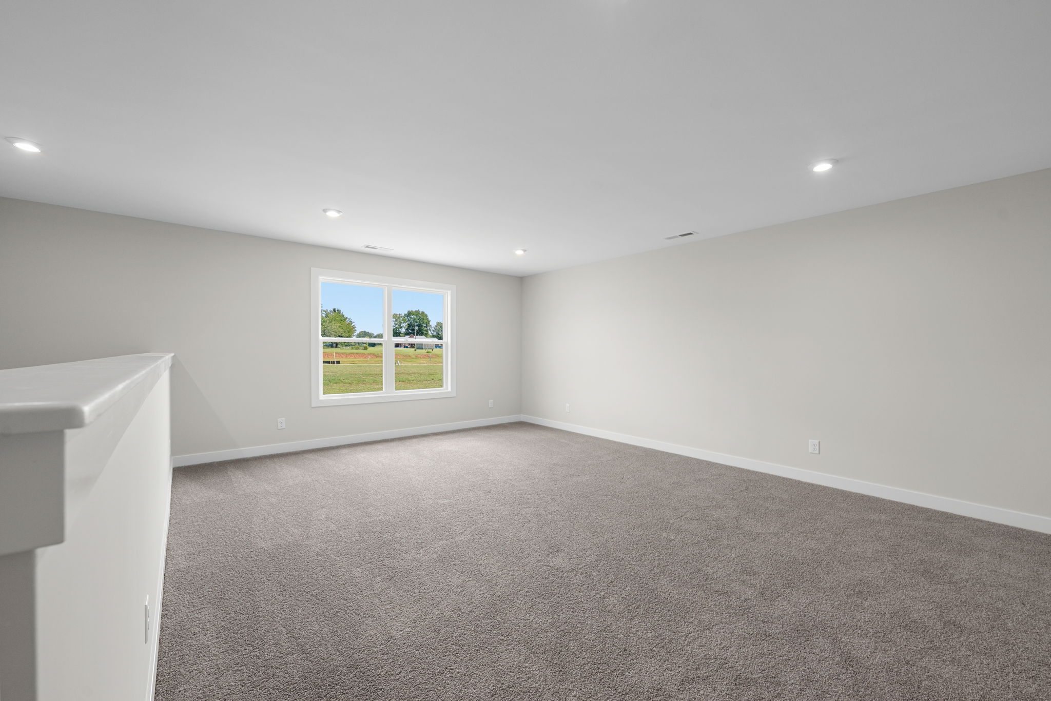 Carpeted bonus room measuring 15 by 19 feet 11 inches at 9312 Woodgate Circle in Alvaton, KY