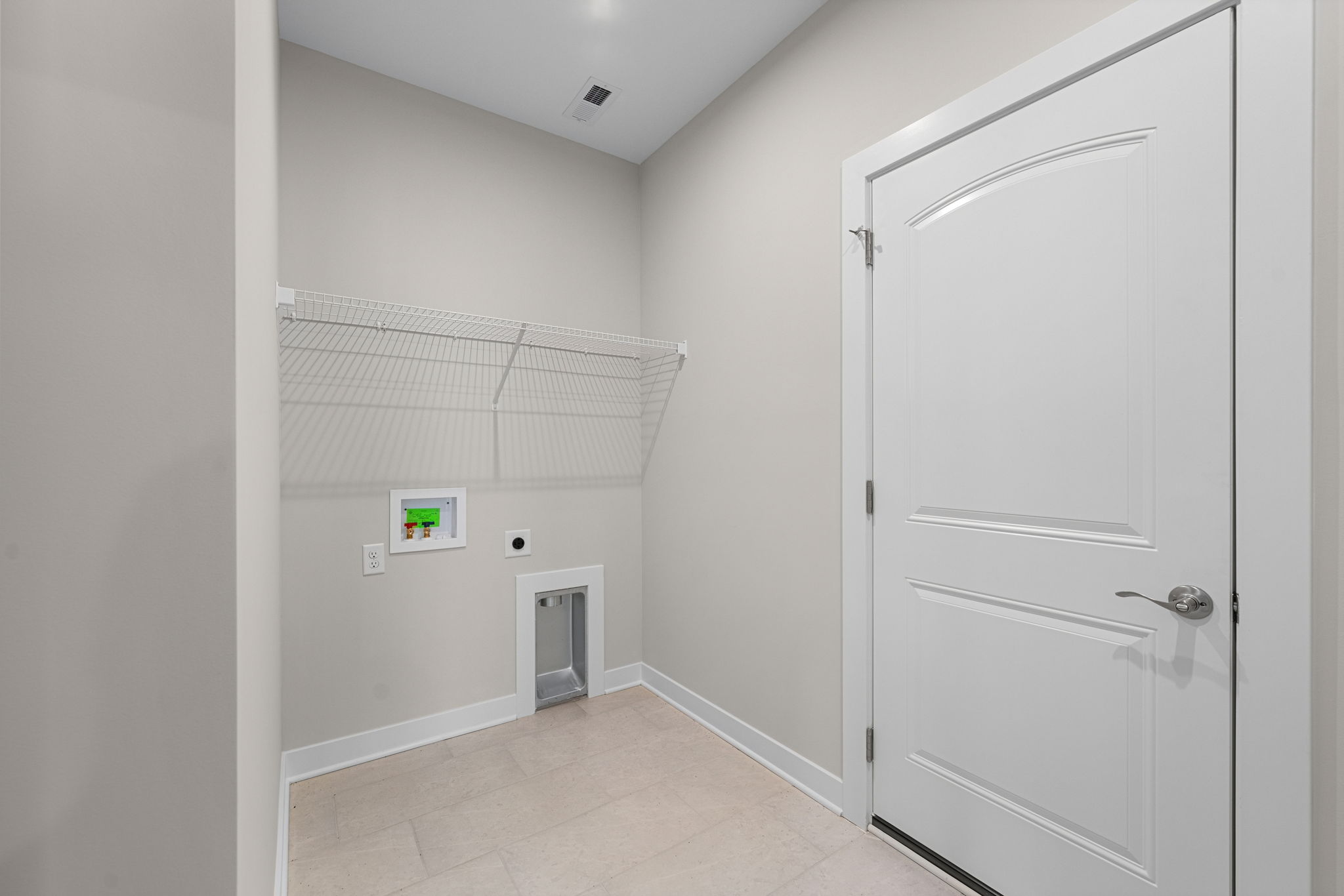 Main-level laundry and utility room at 9312 Woodgate Circle in Alvaton, KY