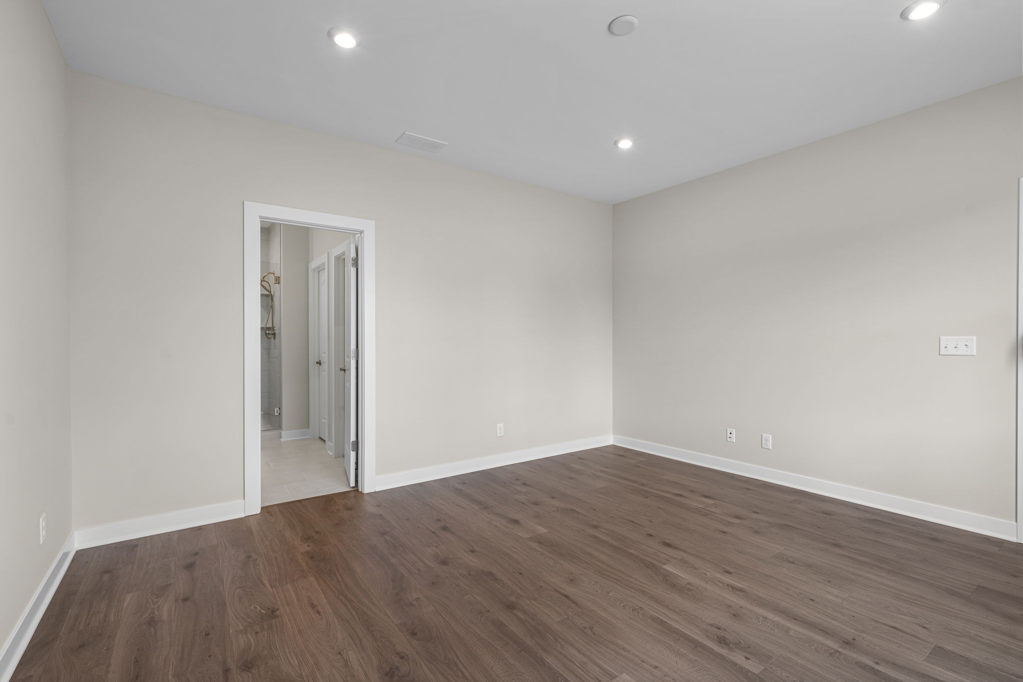 Primary bedroom with entry to the private bath at 9312 Woodgate Circle in Alvaton, KY