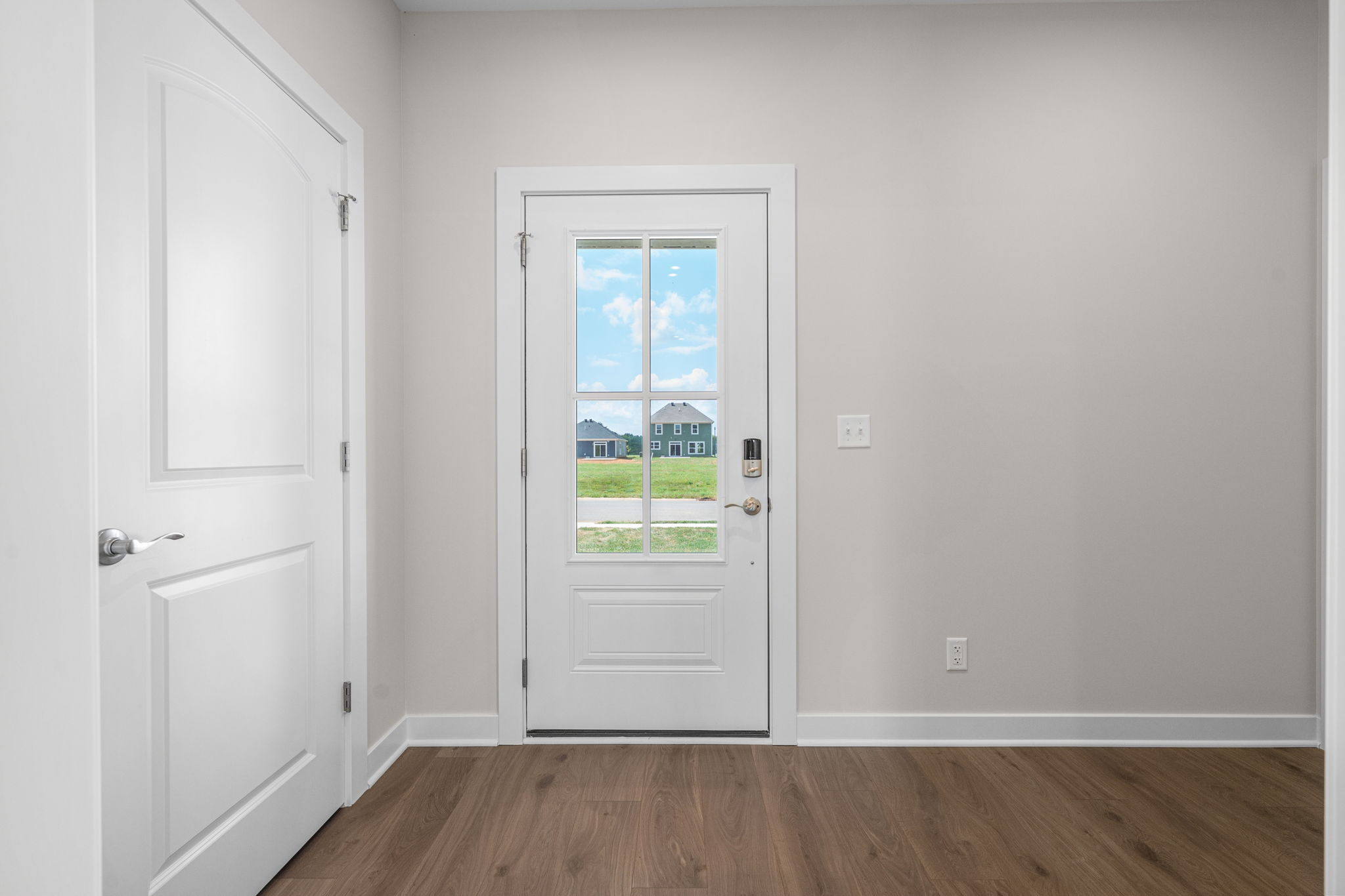 Entry foyer with wood-look flooring at 9312 Woodgate Circle in Alvaton, KY