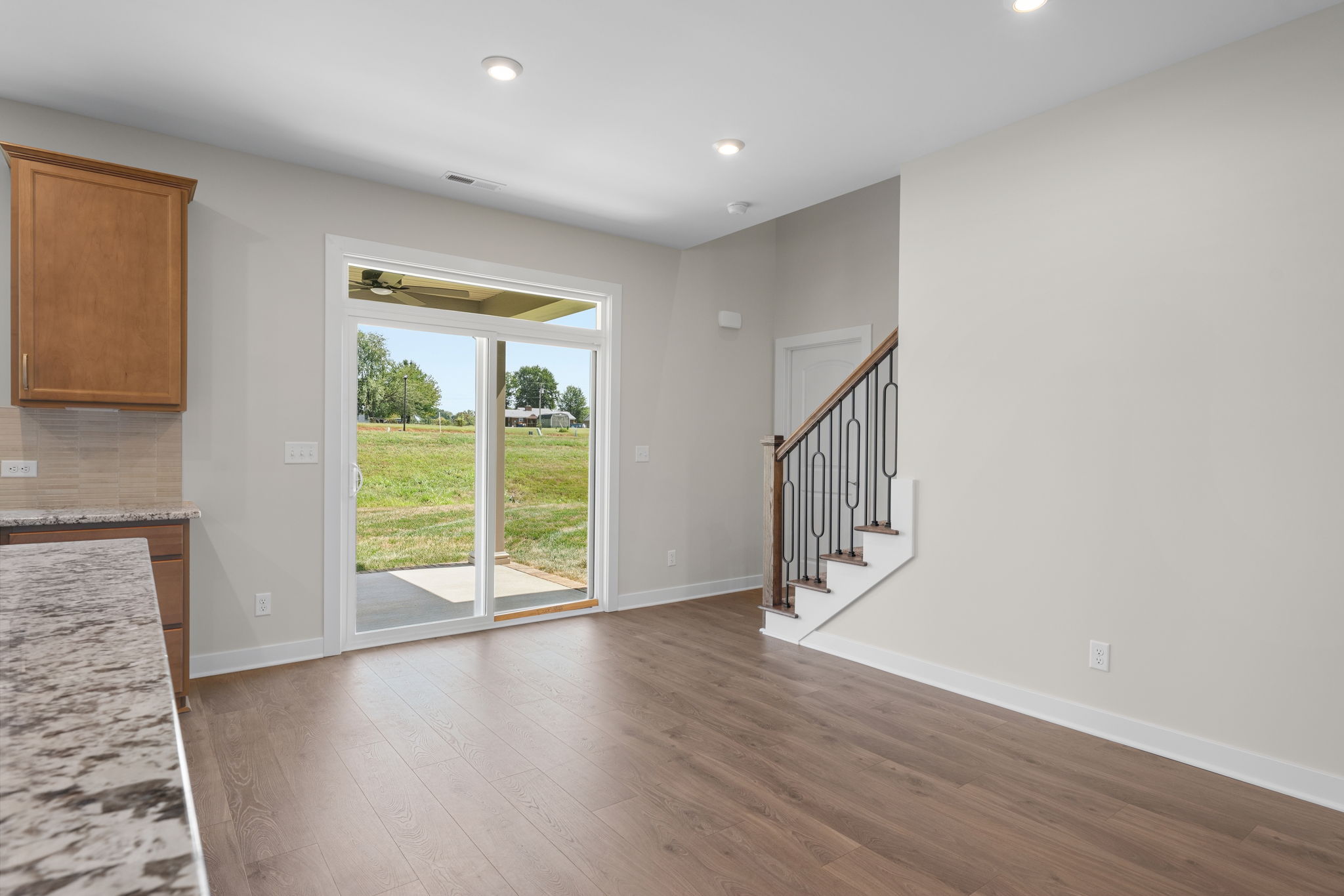 Dining space with backyard access and staircase at 9312 Woodgate Circle in Alvaton, KY