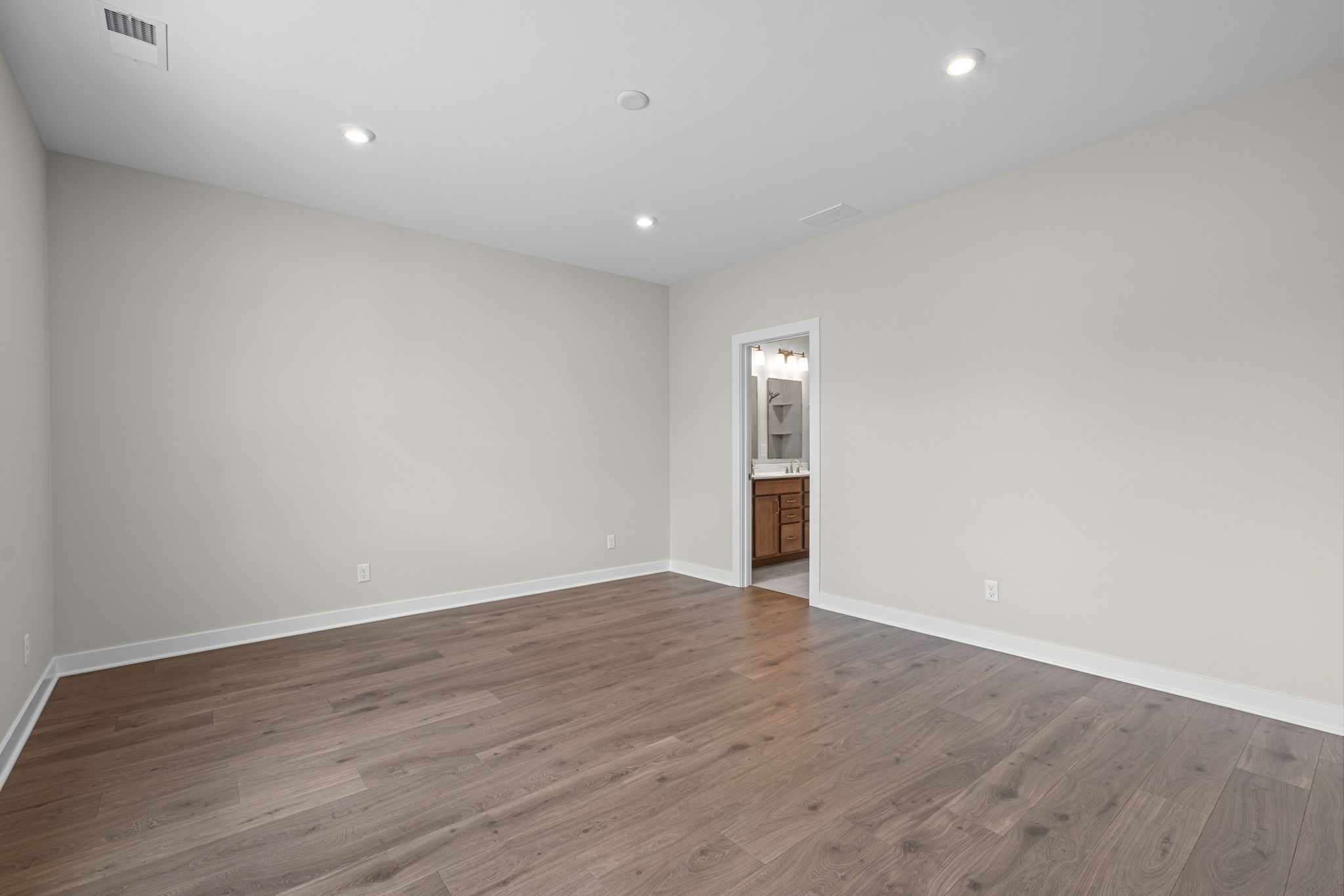 Main-level primary bedroom measuring 15 by 13 feet 10 inches at 9312 Woodgate Circle in Alvaton, KY