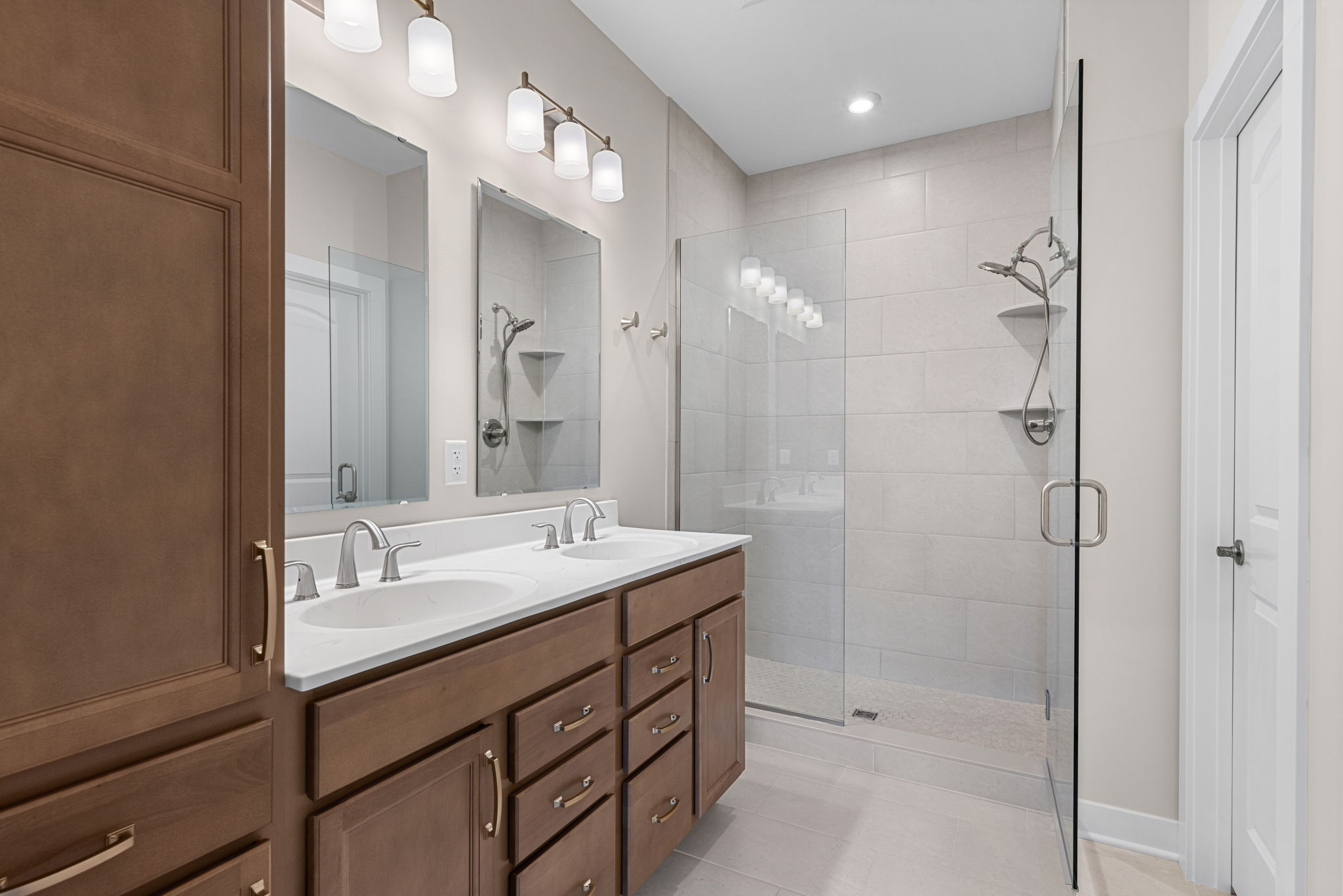 Primary bathroom with double vanity and walk-in shower at 9312 Woodgate Circle in Alvaton, KY