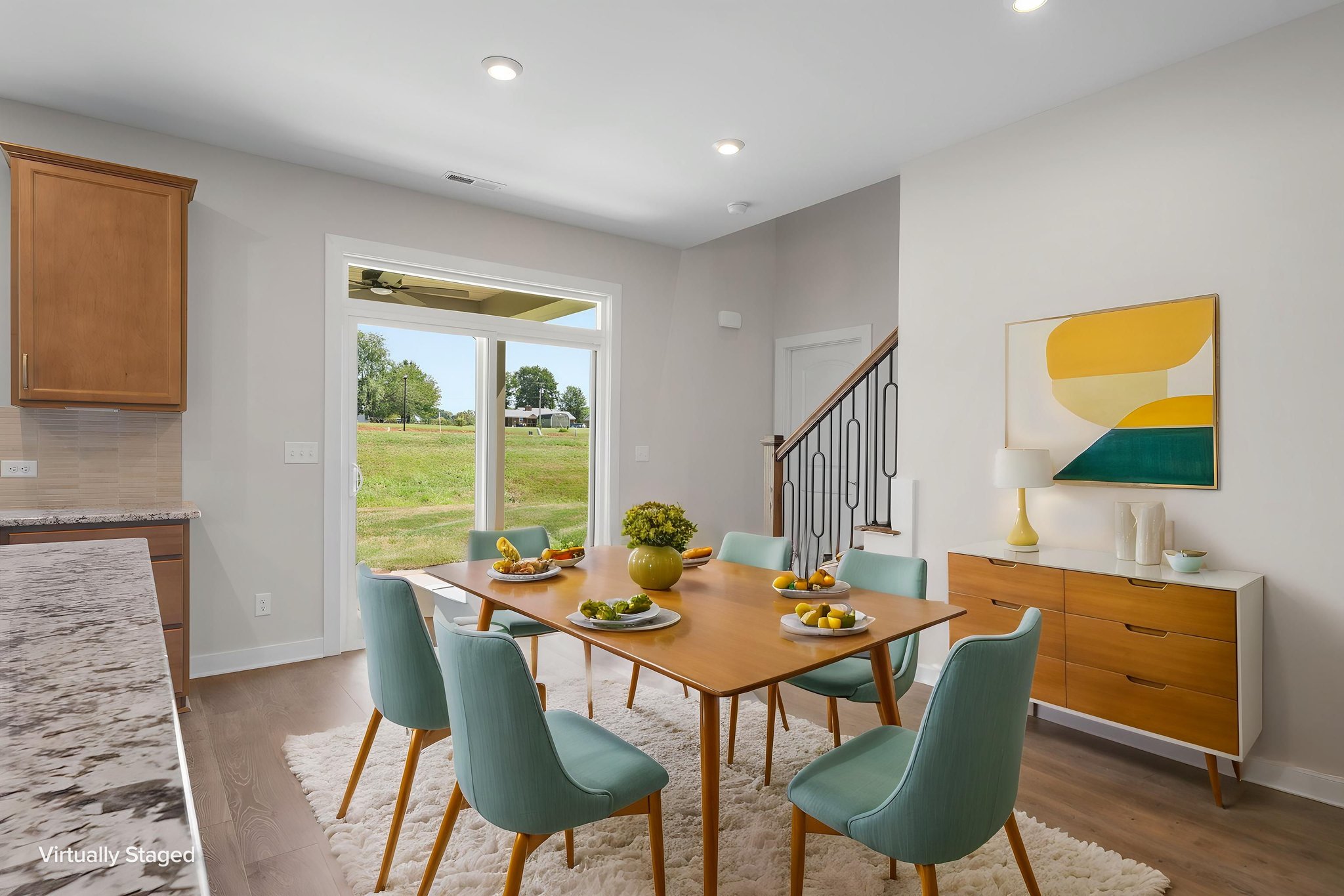 Dining area beside the staircase at 9312 Woodgate Circle in Alvaton, KY, virtually staged